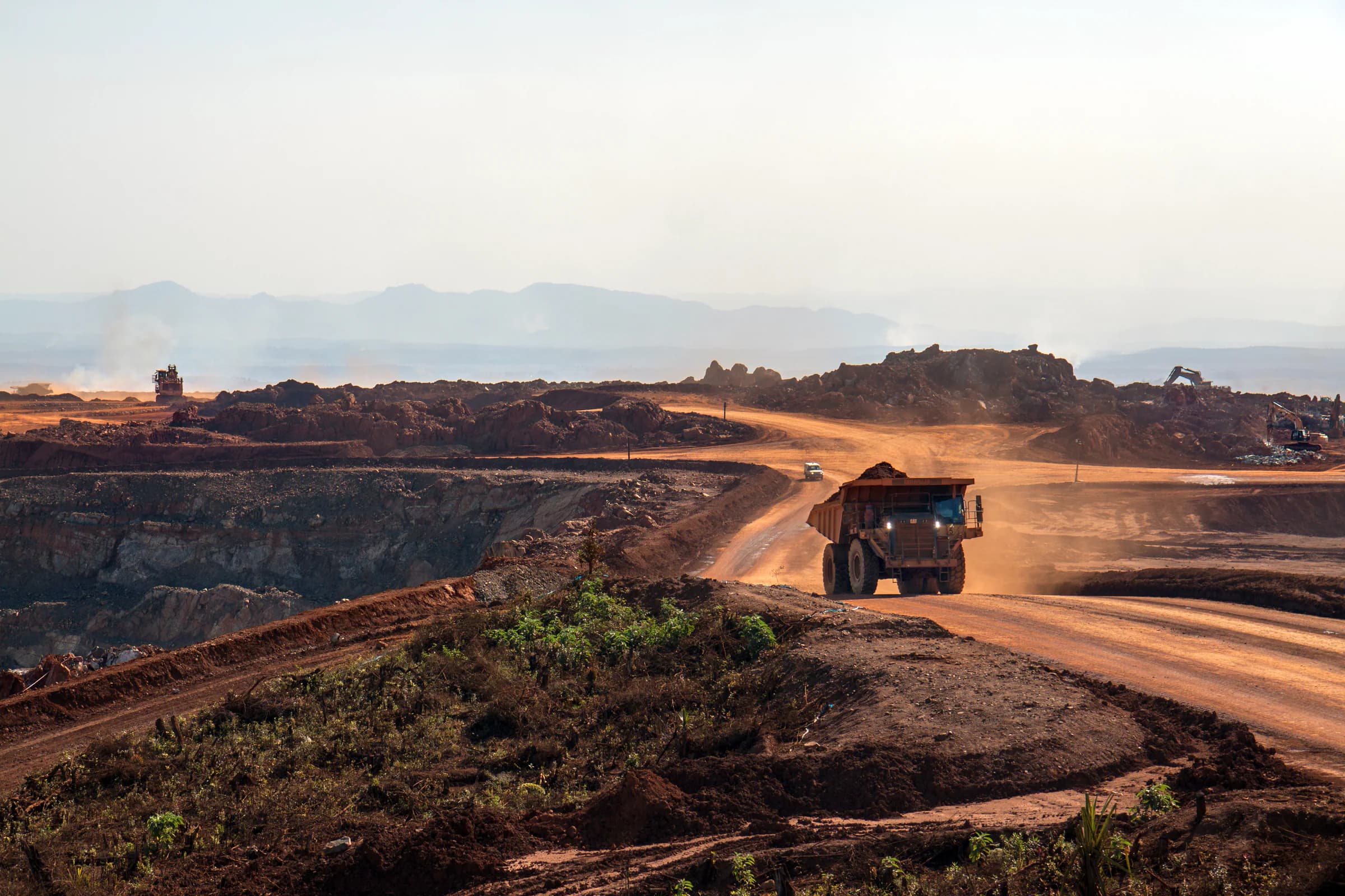 Haul truck traveling along a road at an open-pit mine